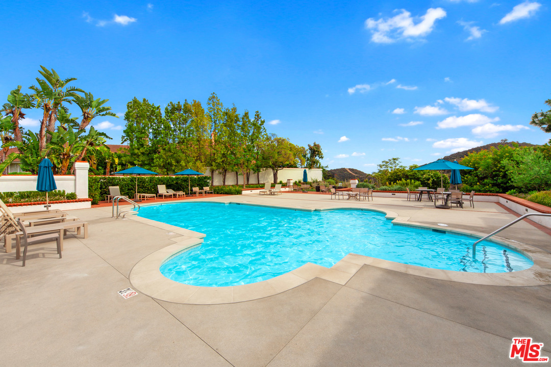 2113 Stoney Hill Road Los Angeles, CA 90049 - Photo 16 of 48 a view of a swimming pool with a patio