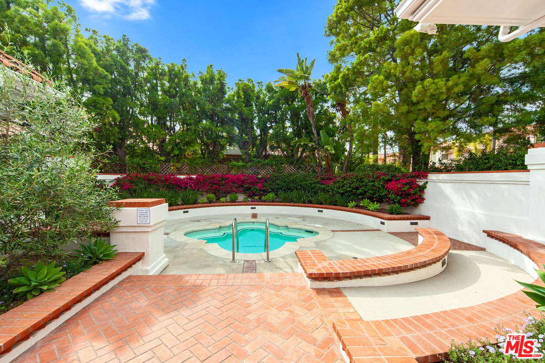 2113 Stoney Hill Road Los Angeles, CA 90049 - Photo 17 of 48 a view of a swimming pool with a yard