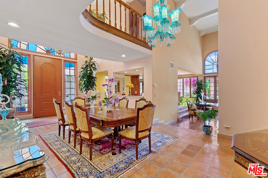 2113 Stoney Hill Road Los Angeles, CA 90049 - Photo 21 of 48 a view of a dining room with furniture and a potted plant