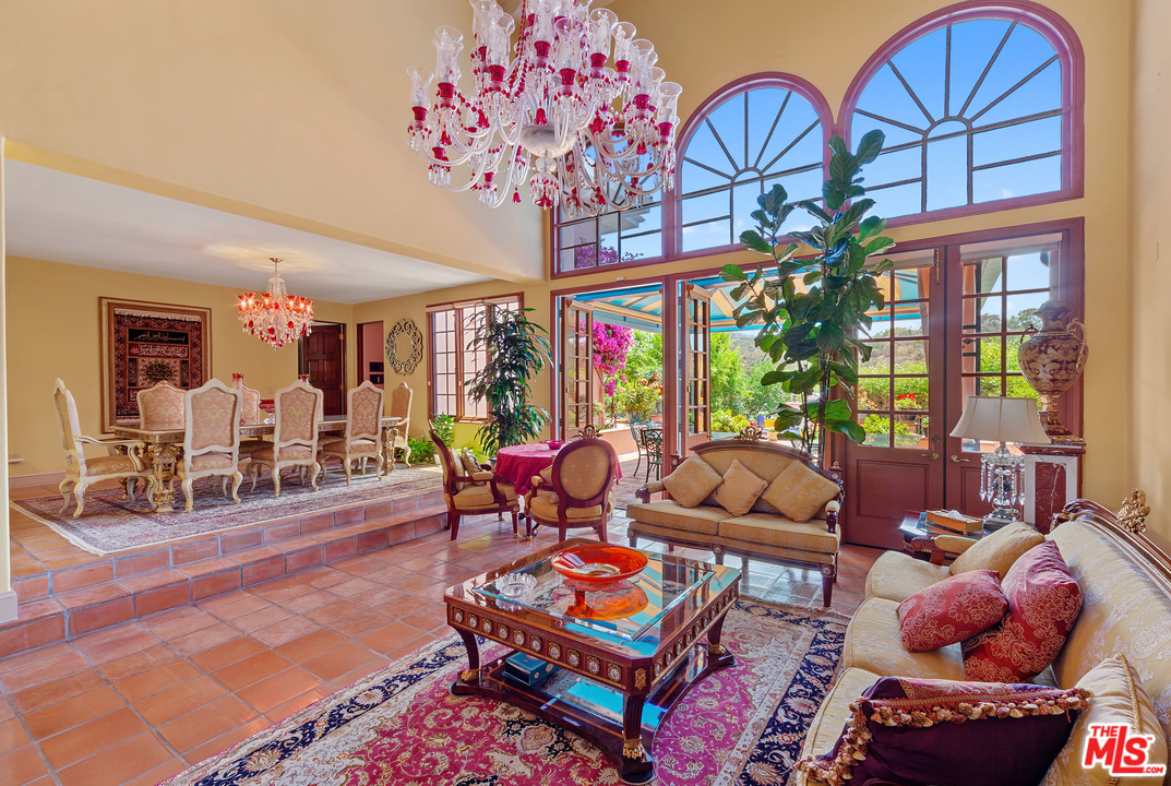 2113 Stoney Hill Road Los Angeles, CA 90049 - Photo 22 of 48 a living room with furniture a chandelier and a rug