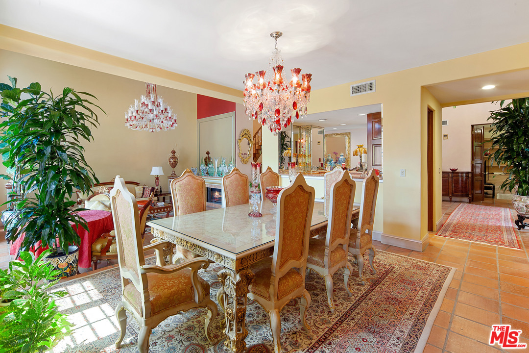 2113 Stoney Hill Road Los Angeles, CA 90049 - Photo 25 of 48 a view of a dining room with furniture and chandelier
