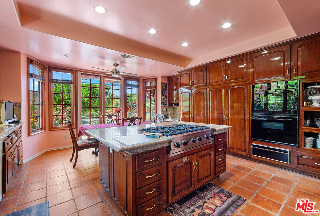 2113 Stoney Hill Road Los Angeles, CA 90049 - Photo 26 of 48 a dining hall with stainless steel appliances granite countertop a stove and cabinets