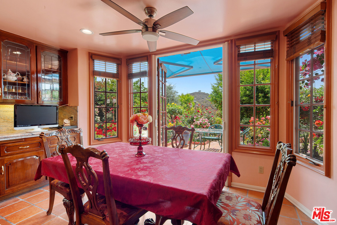 2113 Stoney Hill Road Los Angeles, CA 90049 - Photo 28 of 48 a view of a dining room with furniture window and outside view