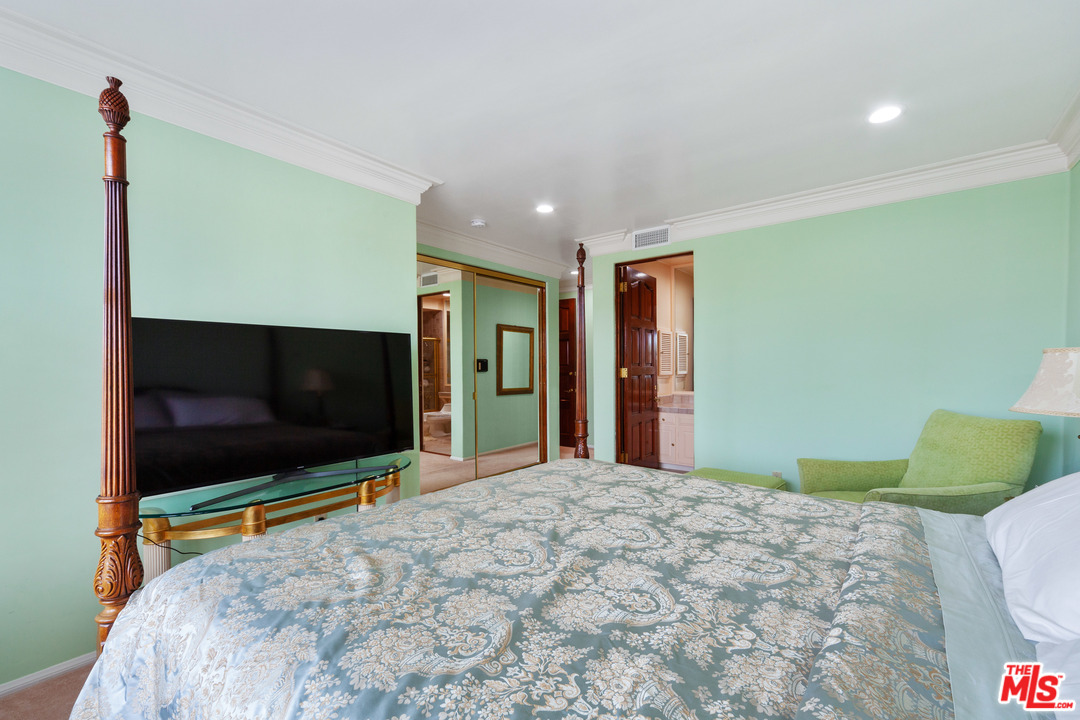 2113 Stoney Hill Road Los Angeles, CA 90049 - Photo 36 of 48 a bedroom with a bed and a flat screen tv