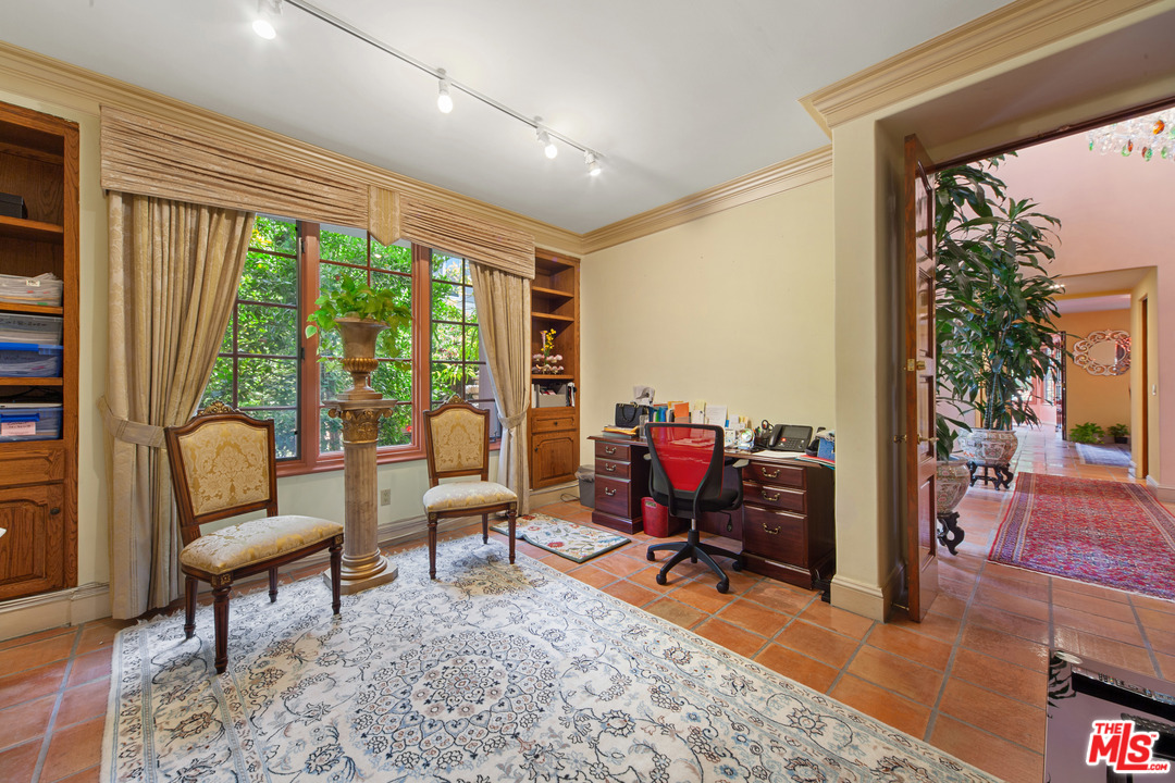 2113 Stoney Hill Road Los Angeles, CA 90049 - Photo 40 of 48 a living room with furniture and a large window