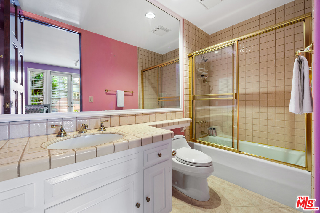 2113 Stoney Hill Road Los Angeles, CA 90049 - Photo 41 of 48 a bathroom with a sink a toilet and shower