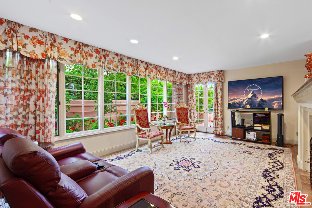 2113 Stoney Hill Road Los Angeles, CA 90049 - Photo 45 of 48 a living room with furniture a window and a flat screen tv