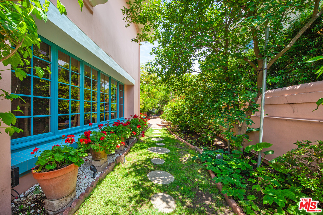 2113 Stoney Hill Road Los Angeles, CA 90049 - Photo 6 of 48 a view of a house with a flower garden
