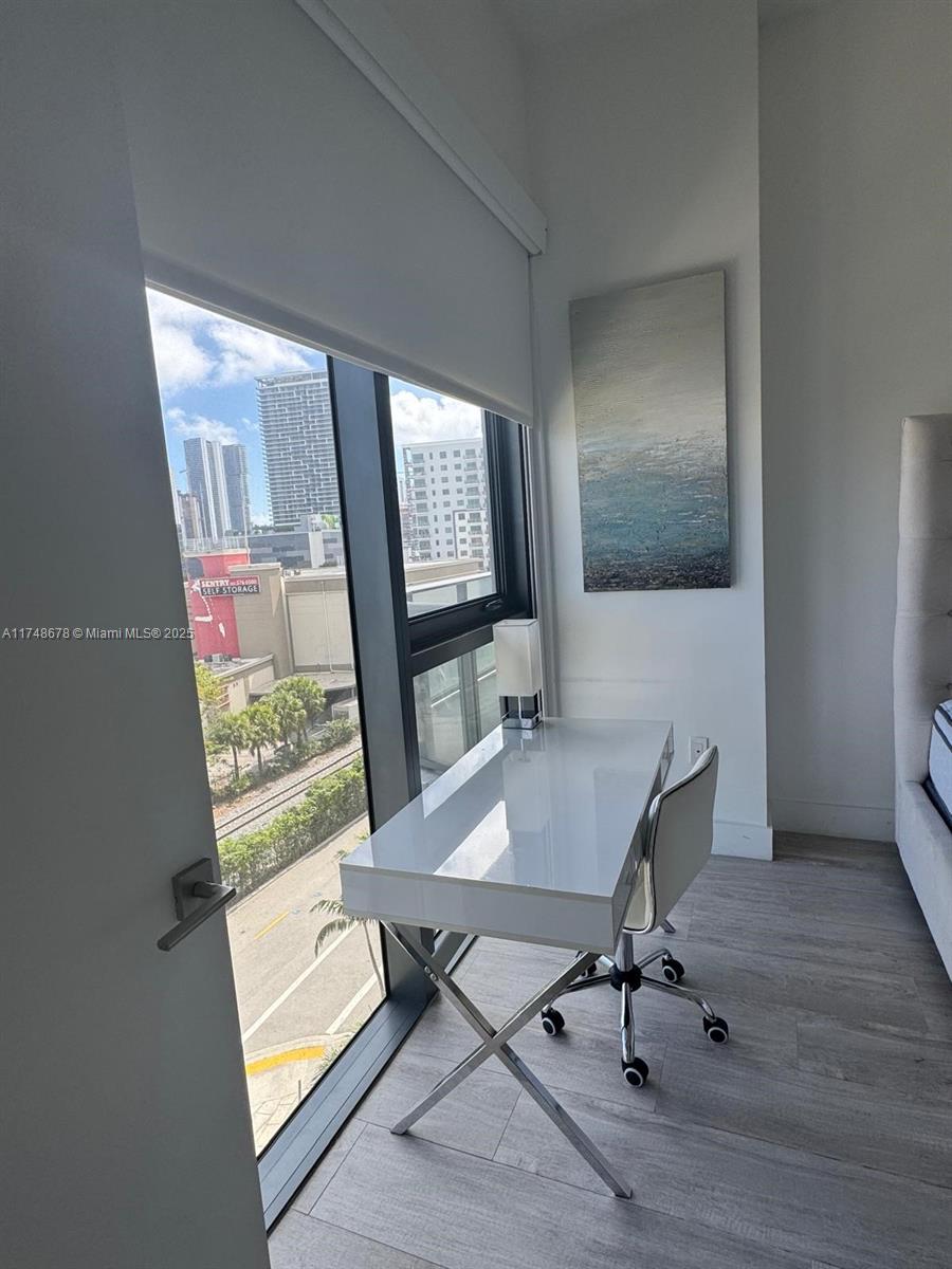 Midtown Miami Miami, FL 33137 - Photo 21 of 21 a view of a workspace with furniture and a window