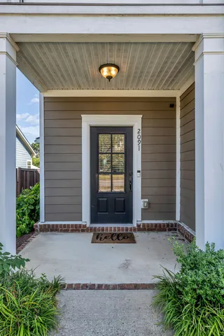 a view of a hallway with wooden floor and entryway