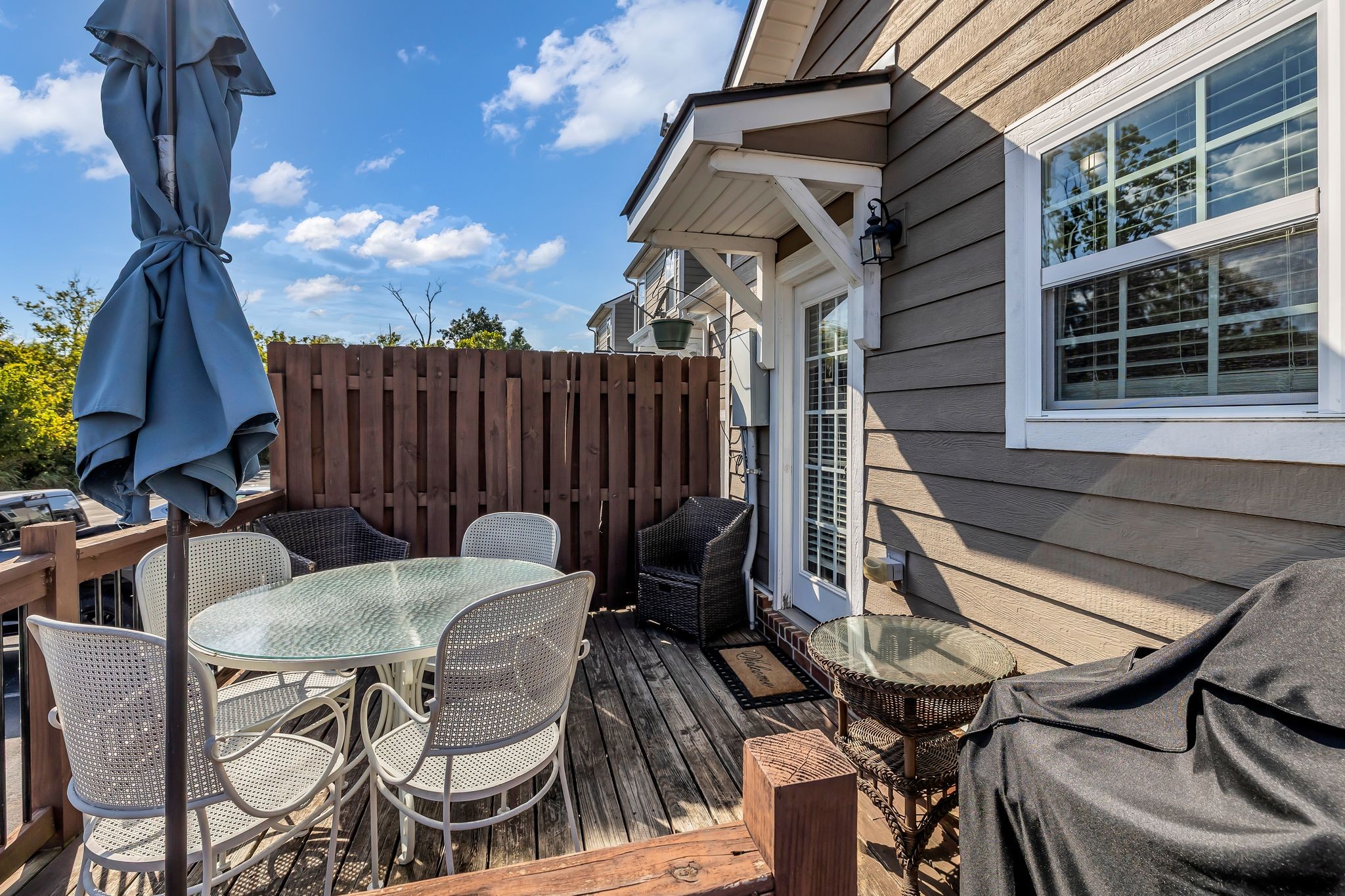 2091 Hemlock Drive Spring Hill, TN 37174 - Photo 22 of 25 a view of a patio with table and chairs with wooden floor and fence