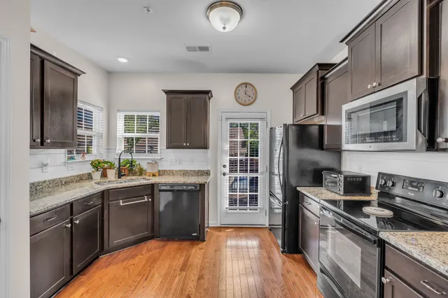 a kitchen with granite countertop a sink and cabinets