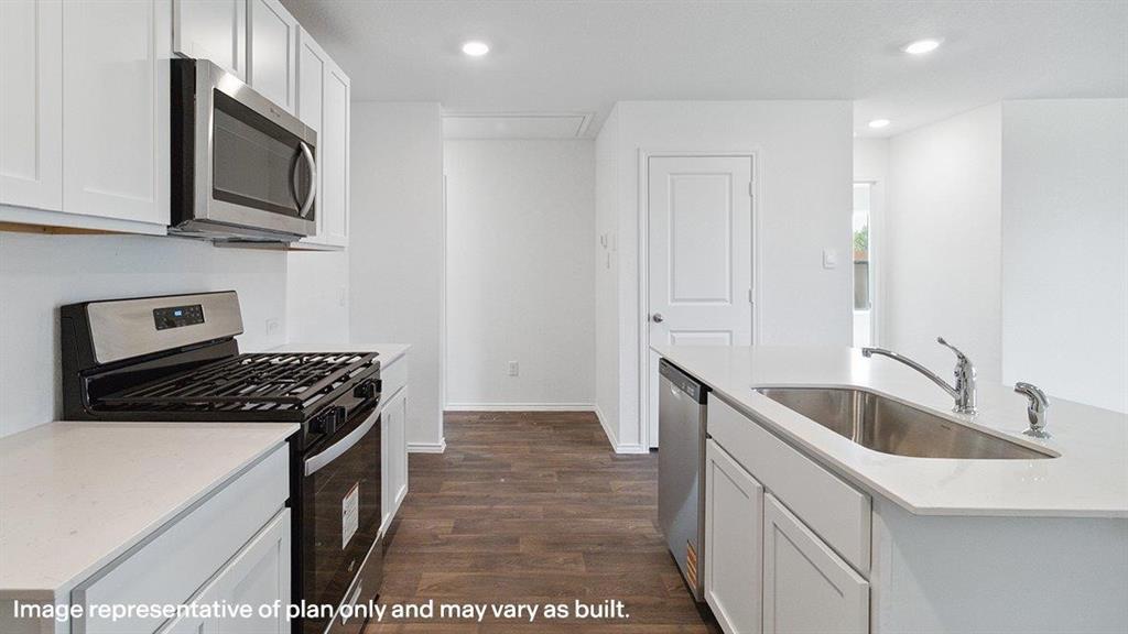 3522 Spring Time Street Forney, TX 75126 - Photo 7 of 27 Kitchen featuring white cabinetry, stainless steel appliances, wood-finish flooring, recessed lighting, and a kitchen island with an undermount sink