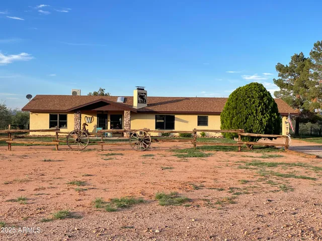 a view of a house with yard and sitting area