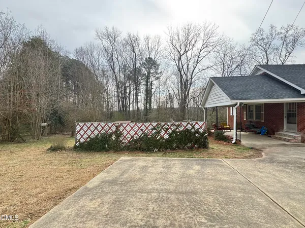 a view of a house with a yard and garage