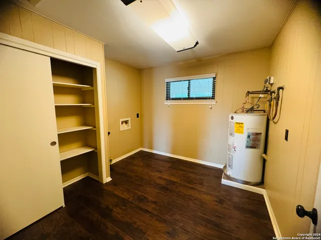 a view of storage and utility room with wooden floor