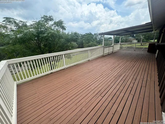 a view of deck with wooden floor and fence