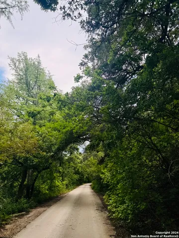 a backyard of a house with a yard and outdoor seating
