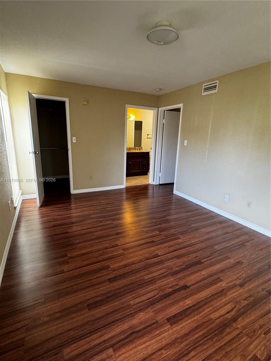 977 Riverside Drive, Unit 221 Coral Springs, FL 33071 - Photo 14 of 17 a view of empty room with wooden floor and fireplace