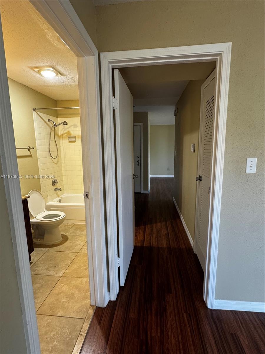 977 Riverside Drive, Unit 221 Coral Springs, FL 33071 - Photo 16 of 17 a bathroom with a granite countertop shower and a sink
