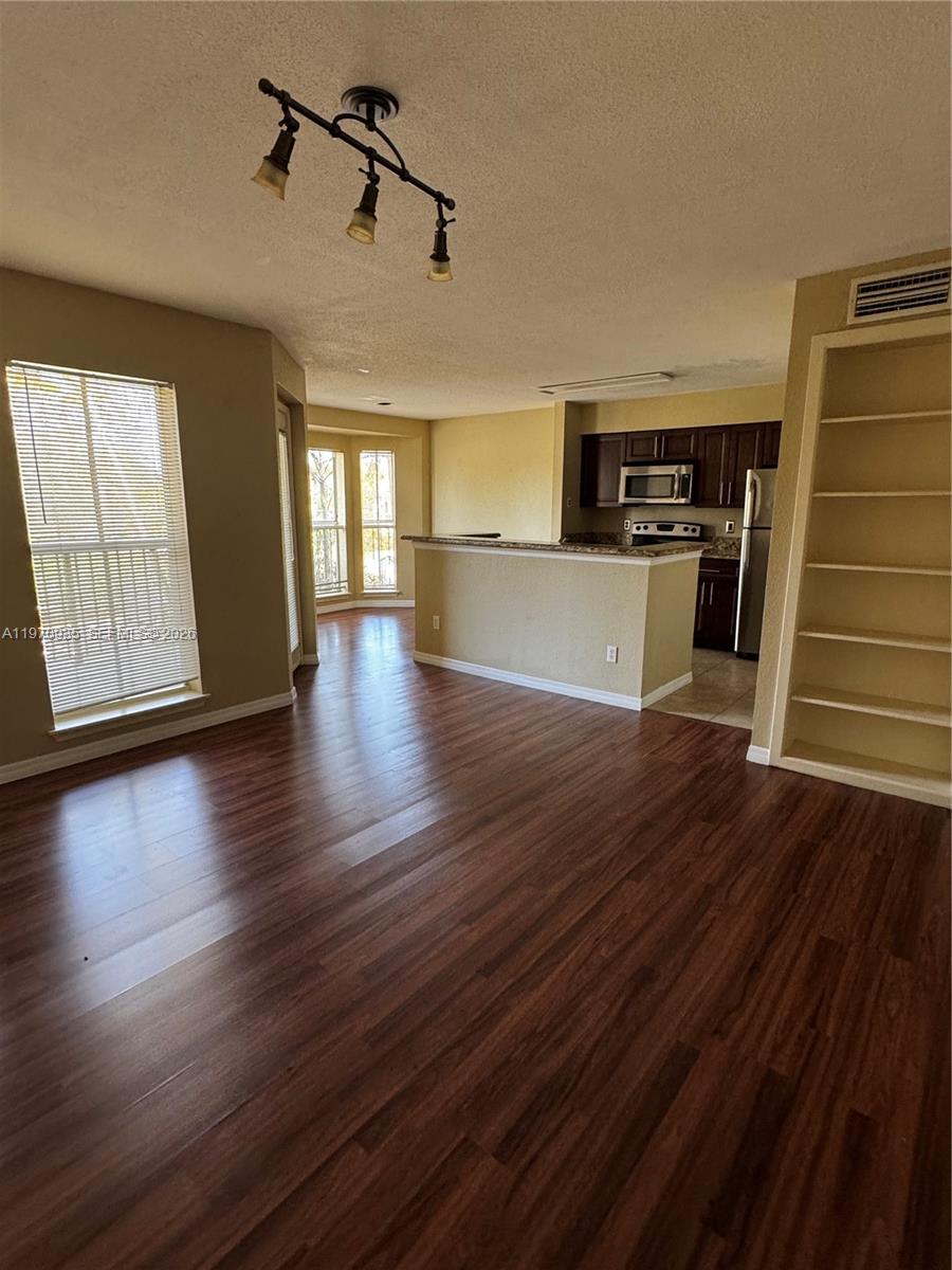977 Riverside Drive, Unit 221 Coral Springs, FL 33071 - Photo 4 of 17 a view of a livingroom with wooden floor and staircase