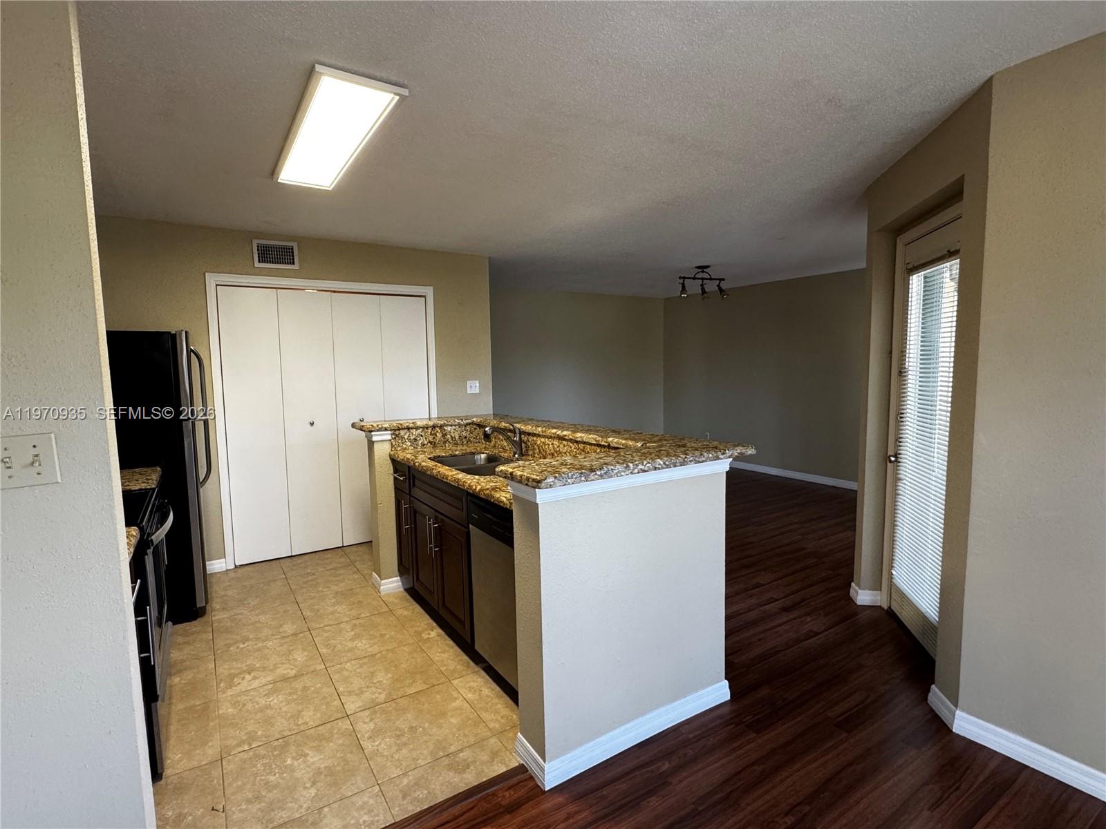 977 Riverside Drive, Unit 221 Coral Springs, FL 33071 - Photo 10 of 17 a view of kitchen and utility room