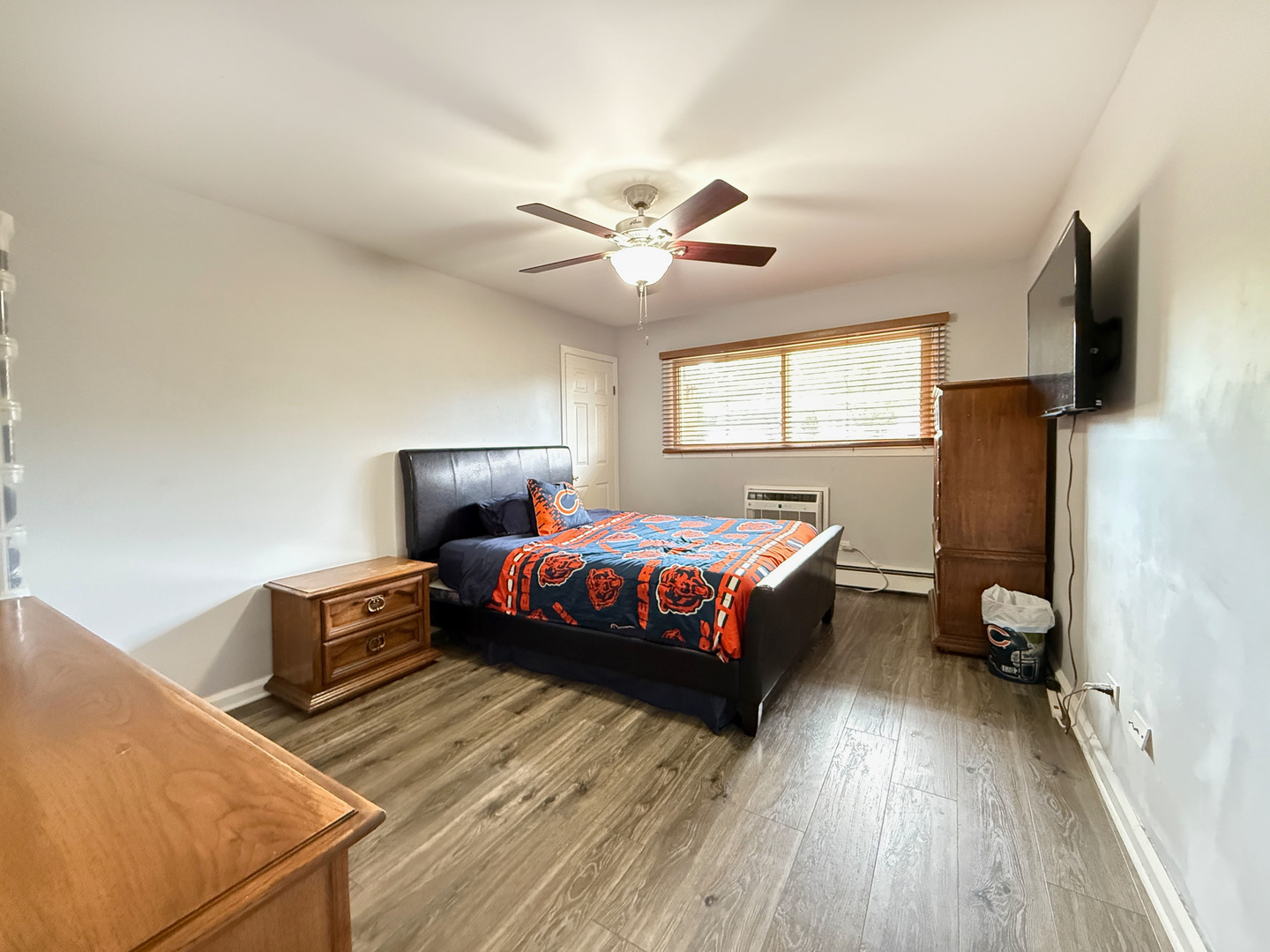 1313 Rebecca Road, Unit 118 Lombard, IL 60148 - Photo 15 of 19 a spacious bedroom with a bed and a flat screen tv