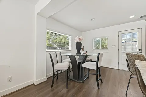 a view of a dining room with furniture and a window