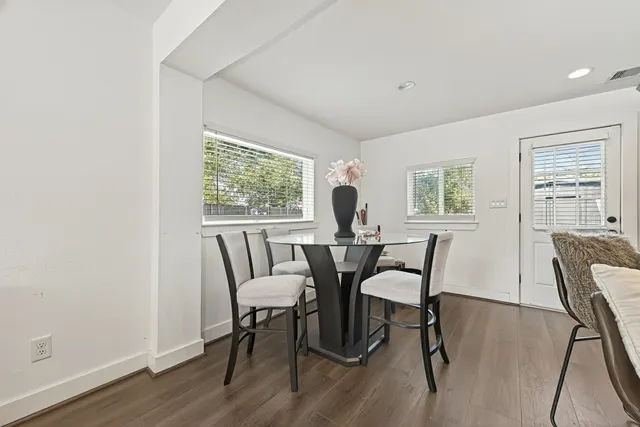 a view of a dining room with furniture and a window