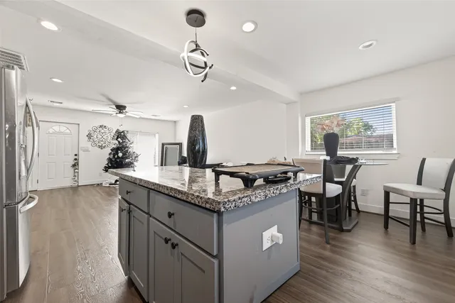 a kitchen with stainless steel appliances granite countertop a stove and a refrigerator