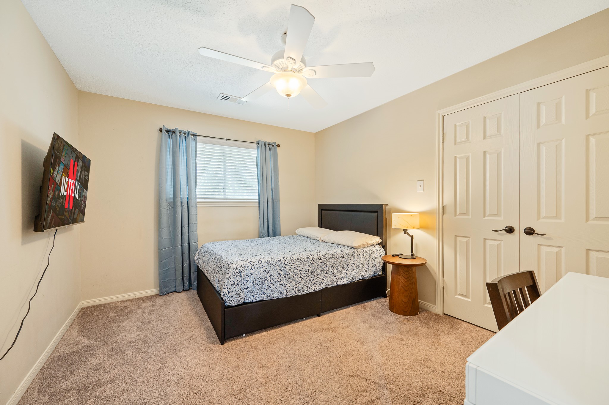 8111 Morningbrook Court Spring, TX 77379 - Photo 34 of 46 a bedroom with a bed and a chandelier