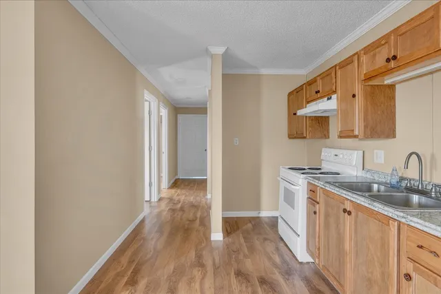a view of a kitchen from a hallway