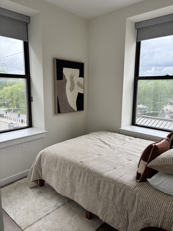 47 Winter Street, Unit 601 Boston, MA 02108 - Photo 4 of 12 a bedroom with a bed and window