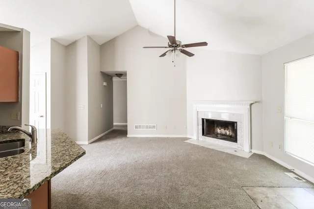 a kitchen with stainless steel appliances granite countertop a refrigerator sink and stove