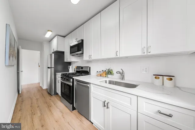 a kitchen with a sink a stove and refrigerator