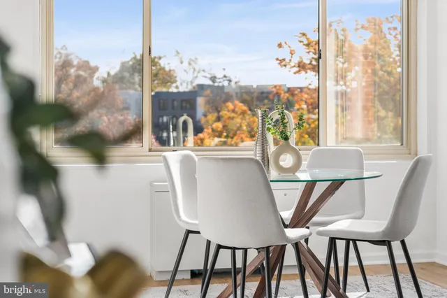 a view of a dining room with furniture and window
