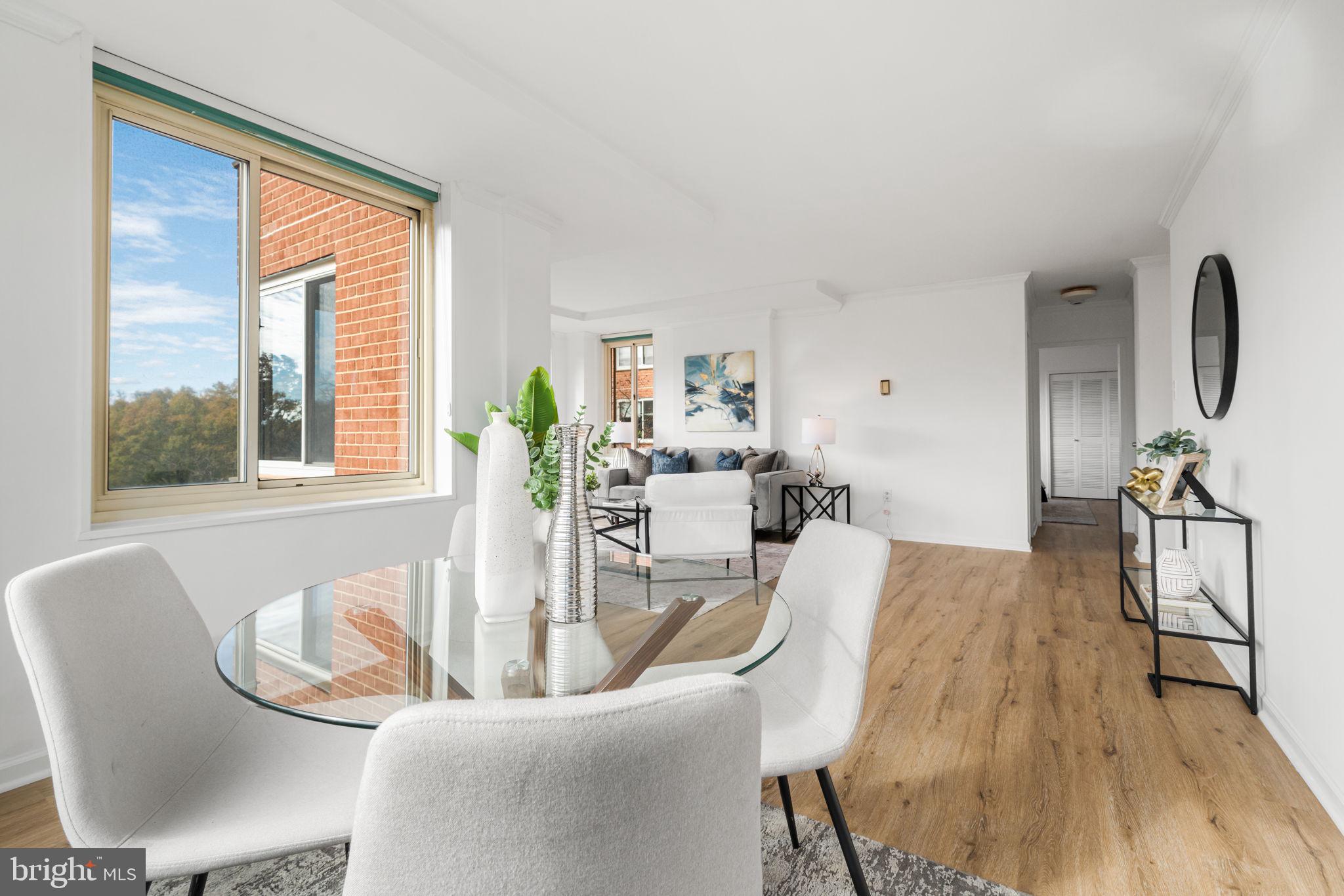 4000 Tunlaw Road Northwest, Unit 811 Washington, DC 20007 - Photo 14 of 51 a view of a dining room with furniture window and wooden floor