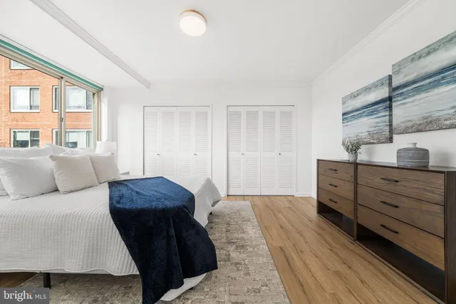 a living room with furniture and a dresser