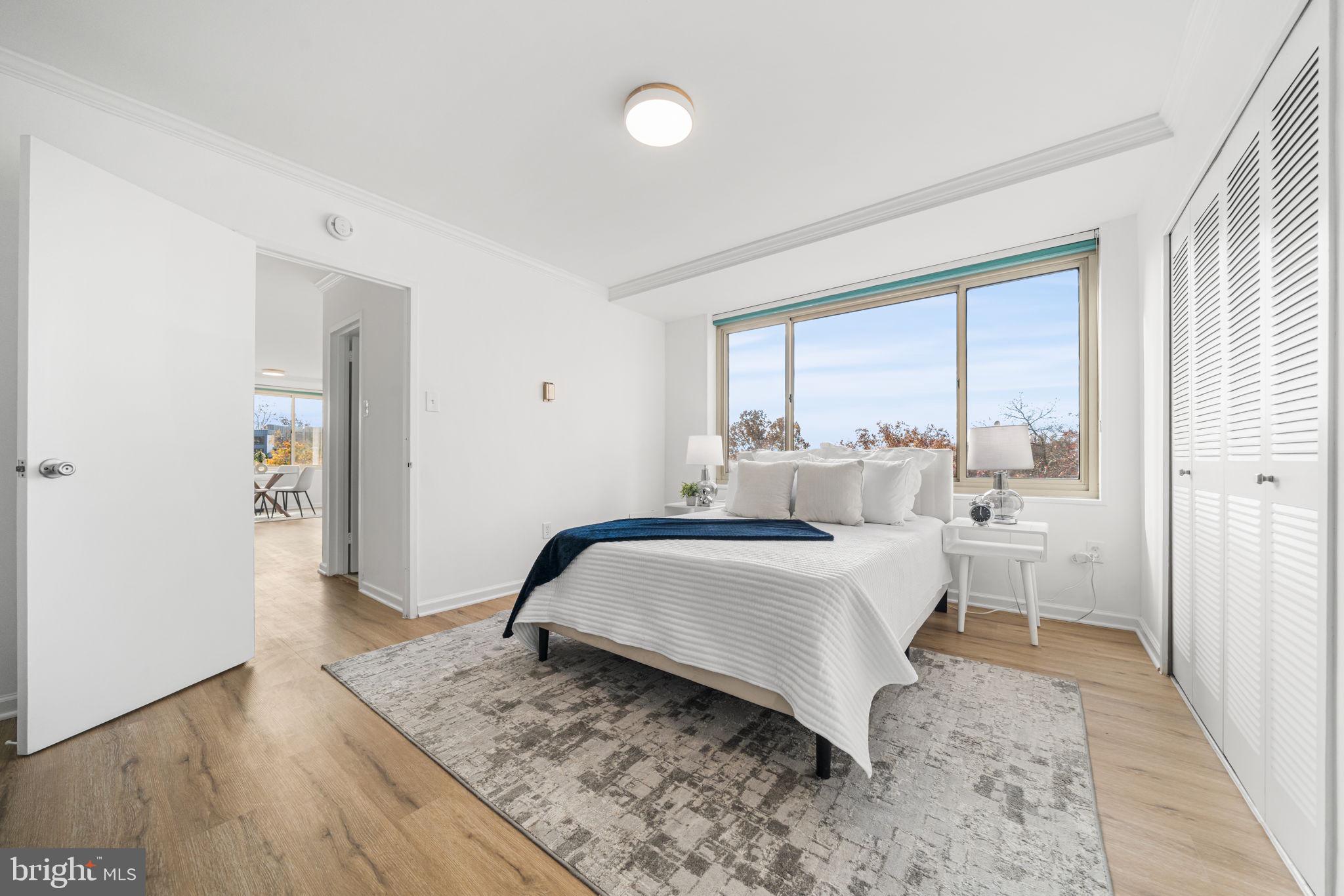4000 Tunlaw Road Northwest, Unit 811 Washington, DC 20007 - Photo 20 of 51 a bedroom with a bed and a large window