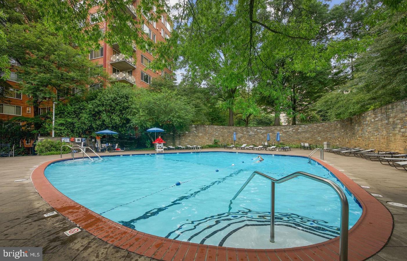 4000 Tunlaw Road Northwest, Unit 811 Washington, DC 20007 - Photo 25 of 51 a view of a swimming pool with a patio and a garden