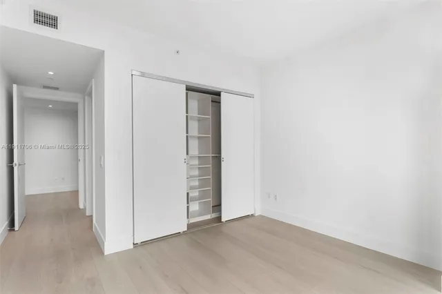 an empty room with closet area