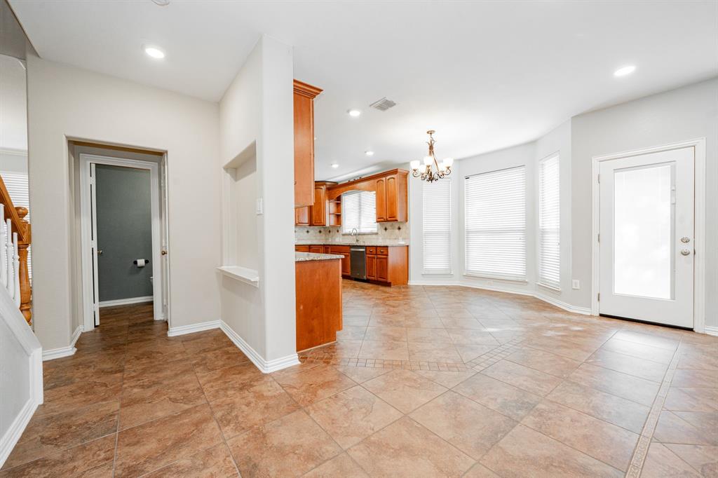 1805 Sumac Drive Flower Mound, TX 75028 - Photo 13 of 40 a view of a kitchen with a sink and a refrigerator