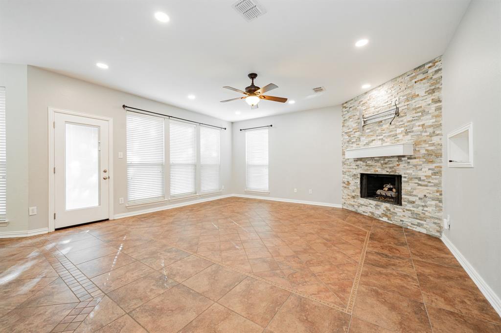 1805 Sumac Drive Flower Mound, TX 75028 - Photo 14 of 40 a view of an empty room with a fireplace and a window