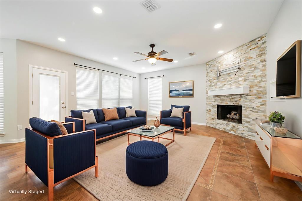 1805 Sumac Drive Flower Mound, TX 75028 - Photo 15 of 40 a living room with furniture a flat screen tv and a fireplace