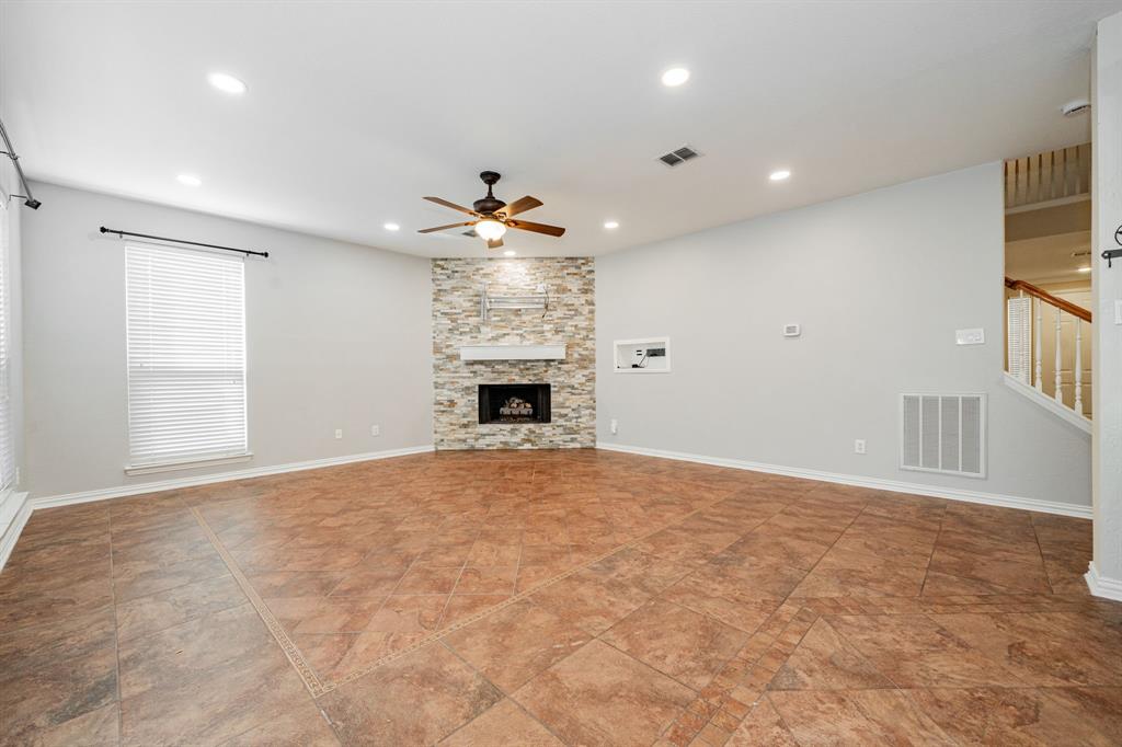 1805 Sumac Drive Flower Mound, TX 75028 - Photo 16 of 40 an empty room with windows and fireplace