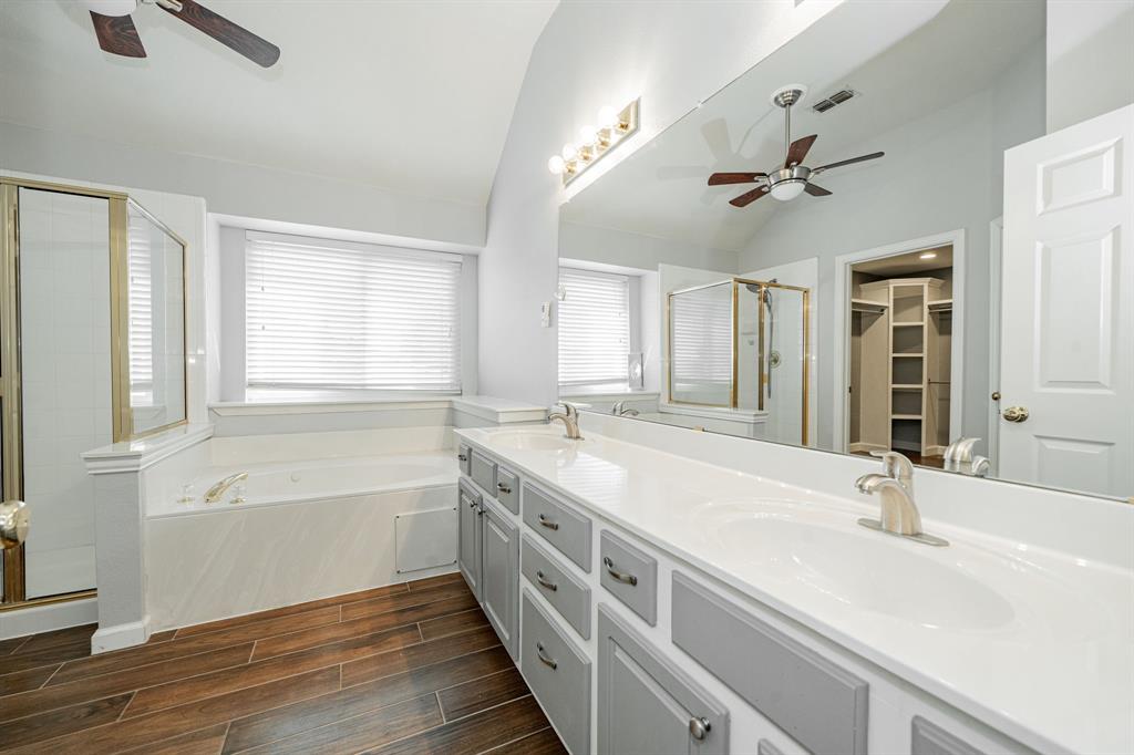 1805 Sumac Drive Flower Mound, TX 75028 - Photo 22 of 40 a spacious bathroom with a double vanity sink a mirror and a bathtub