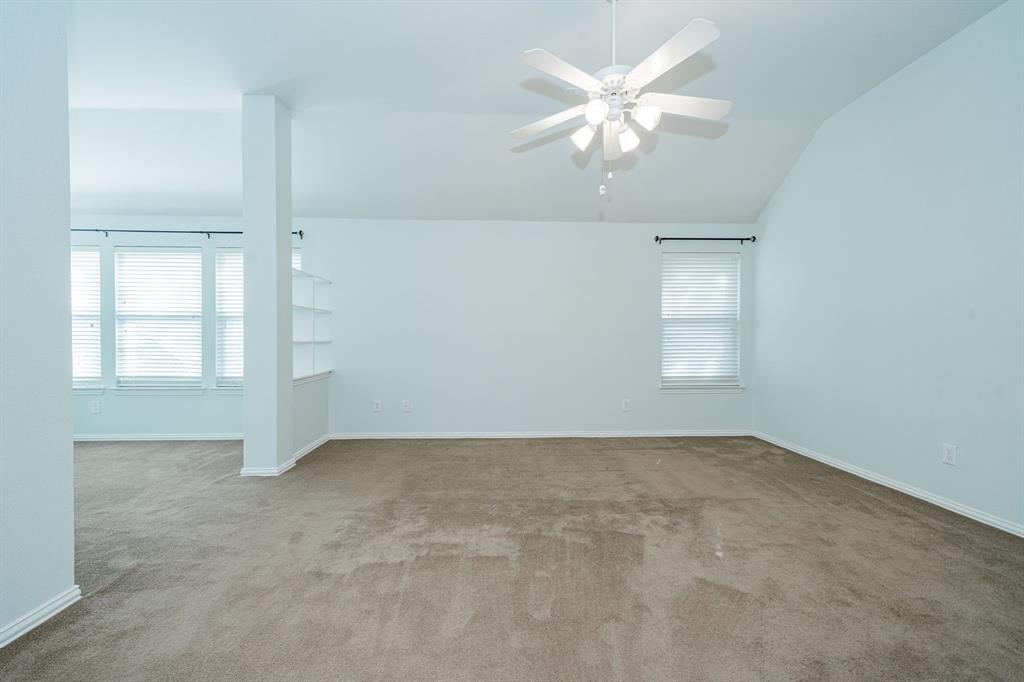1805 Sumac Drive Flower Mound, TX 75028 - Photo 24 of 40 an empty room with chandelier fan and windows