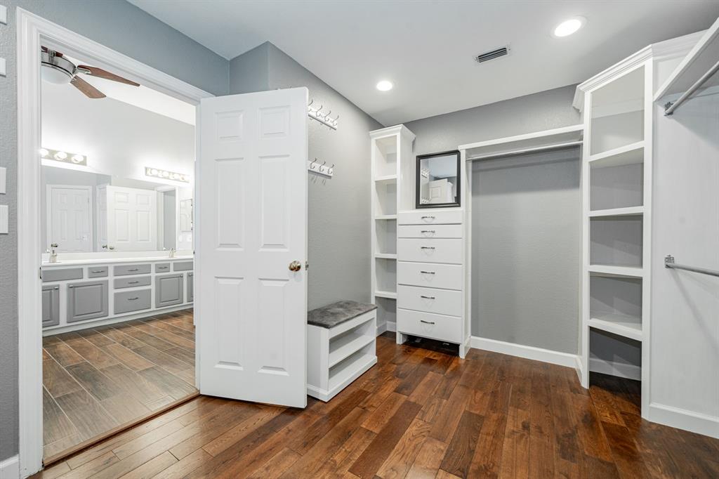 1805 Sumac Drive Flower Mound, TX 75028 - Photo 28 of 40 a view of walk in closet with wooden floor
