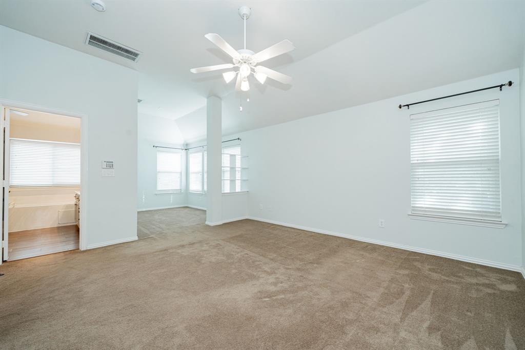 1805 Sumac Drive Flower Mound, TX 75028 - Photo 30 of 40 an empty room with chandelier fan and windows