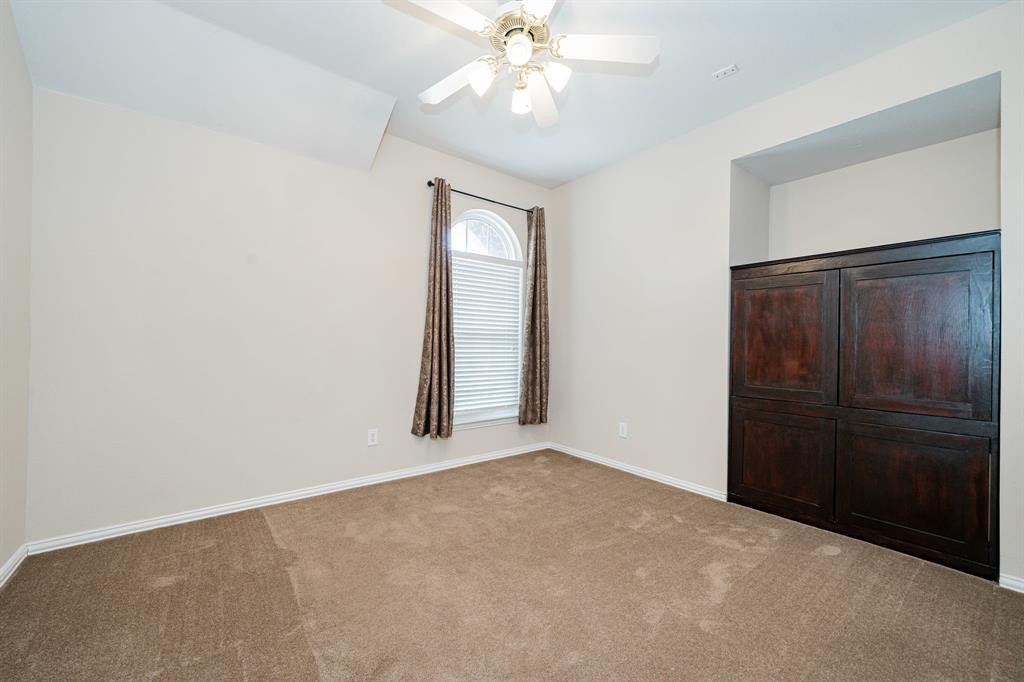 1805 Sumac Drive Flower Mound, TX 75028 - Photo 32 of 40 an empty room with windows and fan